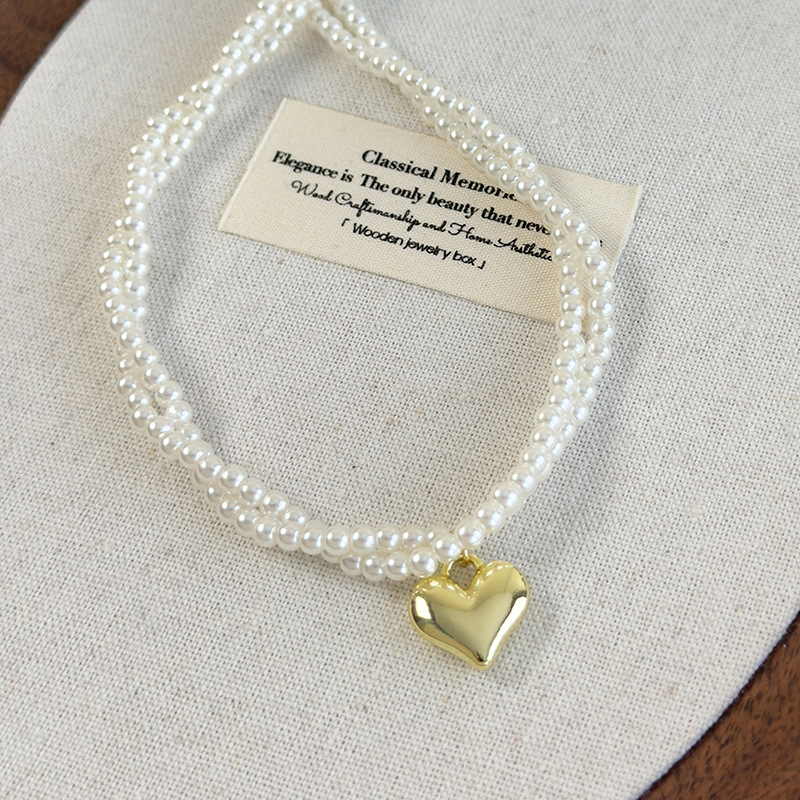 Подвійний намисто-чокер з перлами у вигляді скрученого серця