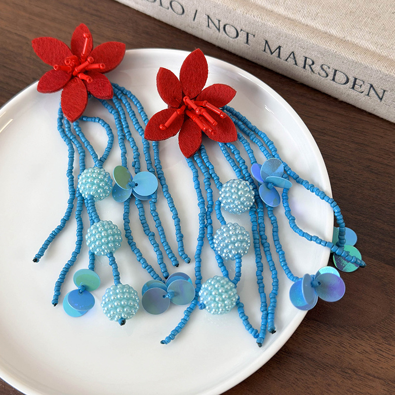 أقراط طويلة بخرز أزرق وزهرة حمراء