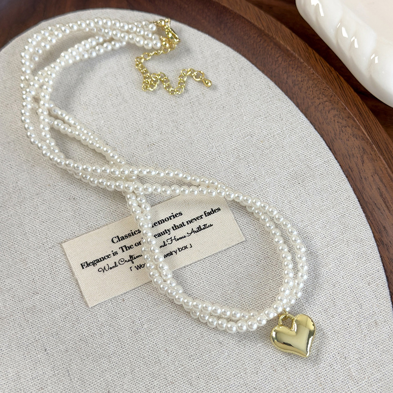 Подвійний намисто-чокер з перлами у вигляді скрученого серця